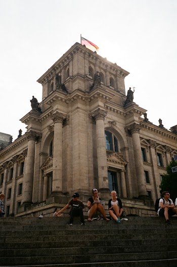 People Sitting on Stairs Near Building