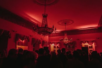 people sitting on table near black and white chandelier