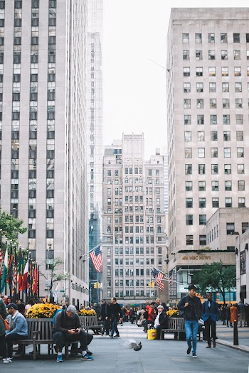 People Standing and Walking on Street