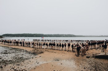 People Standing Beside Body of Water