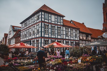 People Standing Beside Flowers Near Building