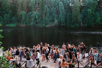 people standing beside lake