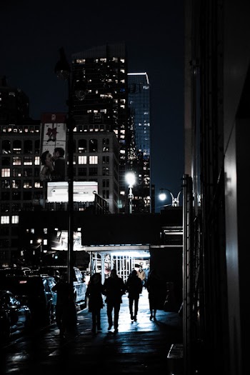 People Standing Beside Lamp Post