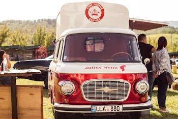 People Standing Beside of Red and White Van