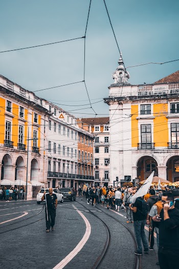 People Standing Beside Road Near Building