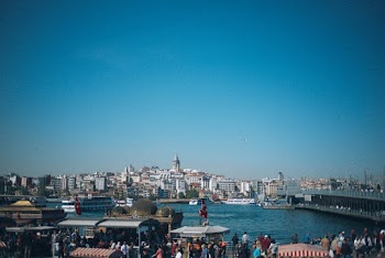 People Standing Near Bridge and Body of Water