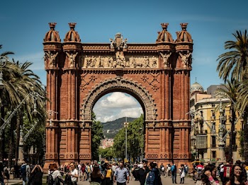 People Standing Near Brown Arched Gate