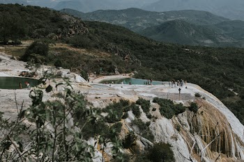 People Standing Near Calm Body of Water