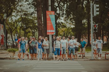 People Standing Near Metal Traffic Post