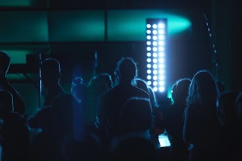 people standing near tower light inside room