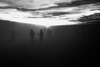 People Standing on Black Surface during Dawn