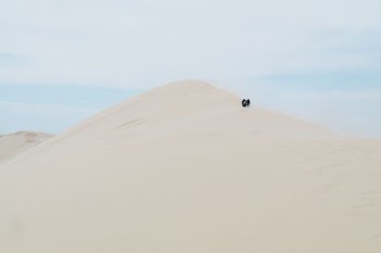 people standing on desert