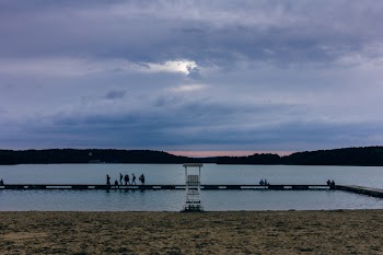 People standing on the pier at dusk