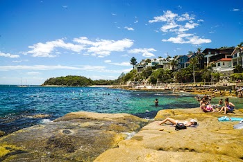 People Sunbathing At The Beach