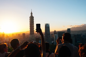 People Taking Photos of High-rise Buildings