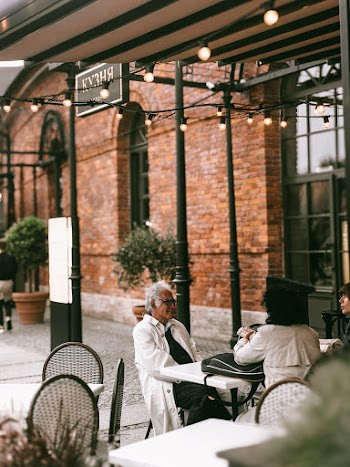 People Talking and Sitting Beside Table