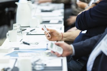 People Trying to Use Devices on Table