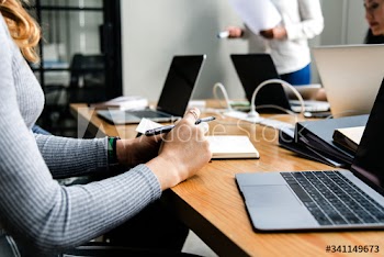 People using laptops in a meeting