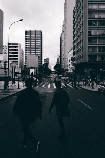 People Walking Across the Streets of the City