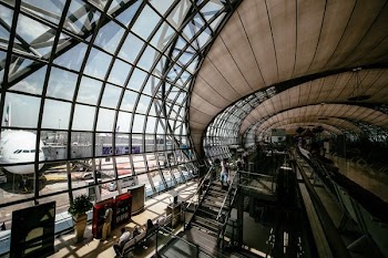 people walking and sitting inside the airport