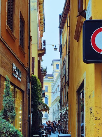 People Walking and Sitting on Alleyway