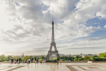 People Walking at the Park With Eiffel Tower View Under Cloudy Sky