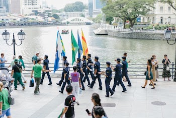 People Walking Beside Body of Water