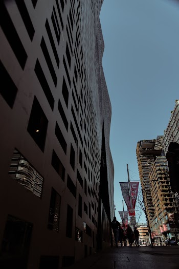 People Walking Beside Building