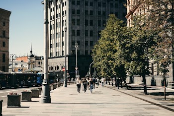 People Walking Beside Concrete Building