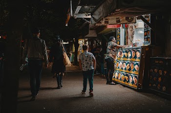 People Walking Beside Food Stall