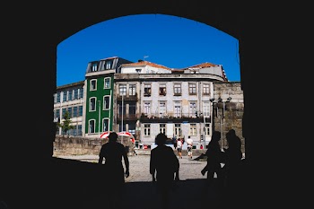 People Walking Beside White and Green Building