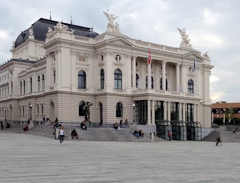People Walking Beside White Concrete Structure