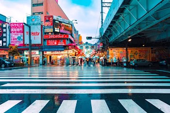 people walking between building