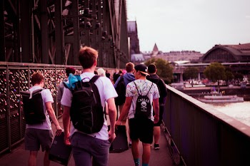 People Walking Between Fences