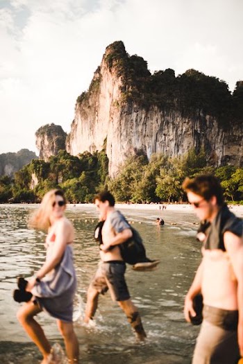 people walking by the beach