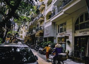 People Walking in Front of Buildings