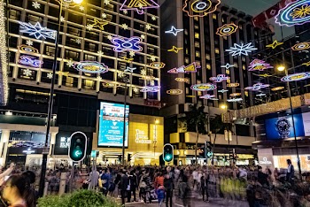 People Walking in Front of Mall during Nighttime