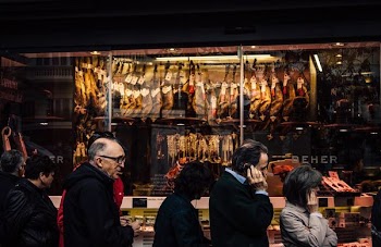 people walking in front of store at night time