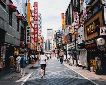 people walking in front of stores during daytime