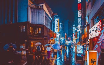 people walking in the middle of city building