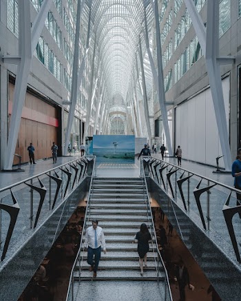 People Walking Inside Glass Building