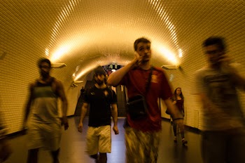People Walking Inside Tunnel Pathway