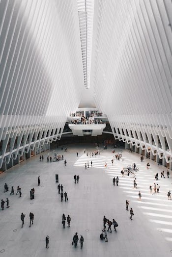 people walking inside white concrete building
