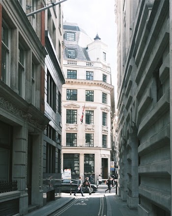 People Walking Near Building and Cars
