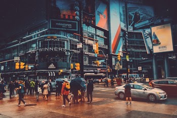 People Walking Near Crossroad Beside Building
