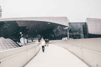People Walking Near Glass and Concrete Building
