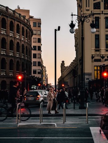 people walking near street beside buildings at daytime