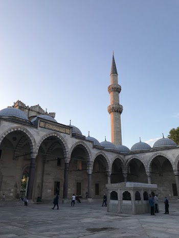 People Walking Near White and Grey Tower
