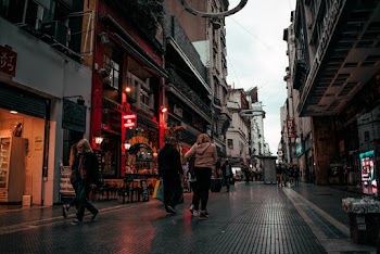 People Walking On Alley Near Buildings