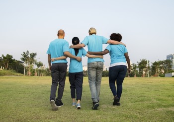 People Walking on Green Grass